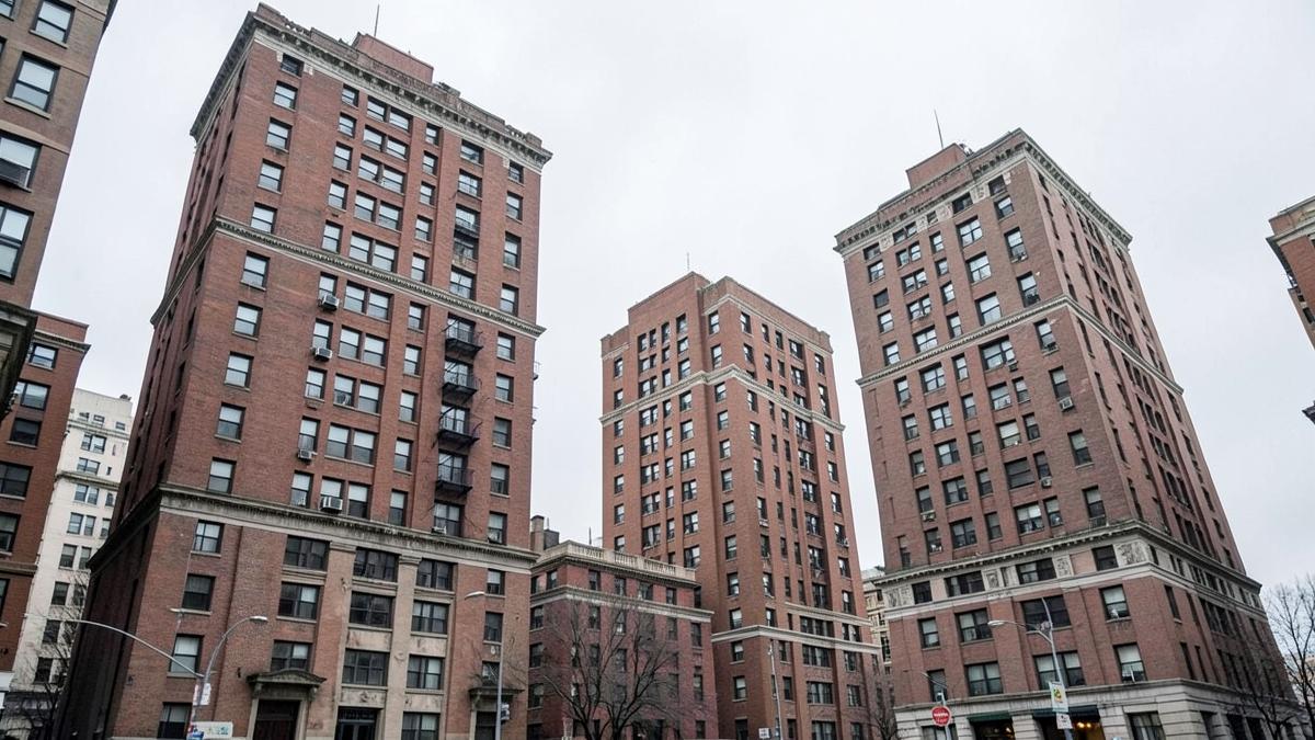 Tall brick residential apartment towers on an overcast day
